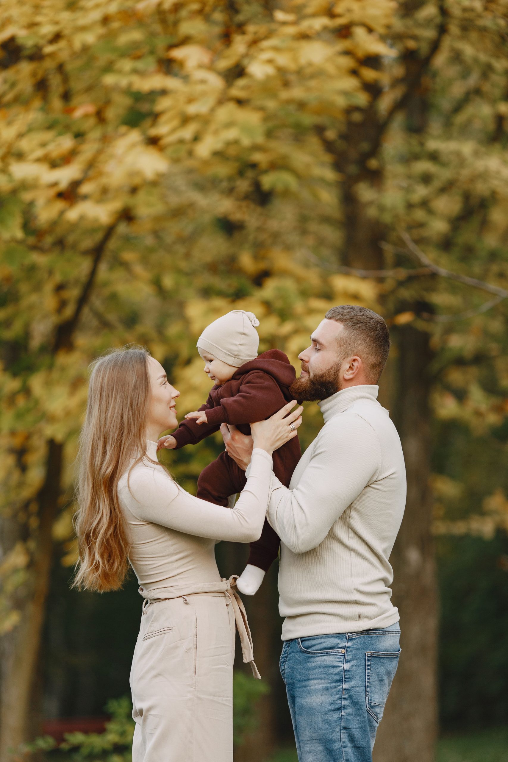family-autumn-park-man-brown-sweater-cute-little-girl-with-parents